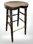 A beech and brass bar stool.