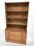 A 20th century Danish teak open bookcase fitted with drawers,