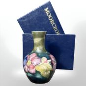 A Moorcroft Clematis bottle vase, height 12.5 cm, boxed.