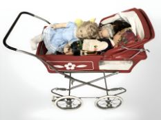 A doll's pram and various dolls.