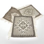 Three small kilim rugs, each approximately 50 cm x 47 cm.