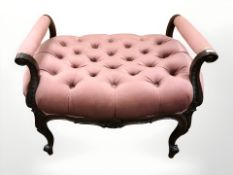 An early 20th century carved mahogany stool in pink dralon,