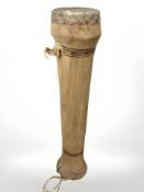 A snakeskin covered tall drum,