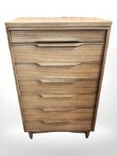A White & Newton teak seven drawer chest,