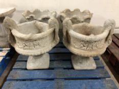 A pair of two handled urns