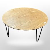 An oak veneered low coffee table on hair pin legs,