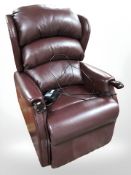 A Burgundy leather electric reclining armchair, width 72 cm.