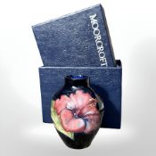 A Moorcroft Hibiscus small bulbous vase, height 8.5 cm, boxed.