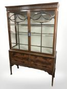 A reproduction mahogany glazed double door display cabinet,