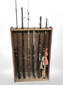 A collection of fishing rods and reels, landing net, etc.