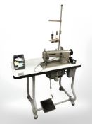 An industrial sewing machine in table,