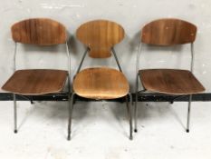 A pair of laminated teak folding metal chairs and a further similar chair