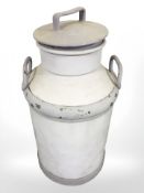 A painted milk churn, height 68 cm.