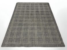 A machined rug on grey ground,