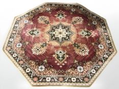 A machine made octagonal rug of Persian design, width 200 cm.