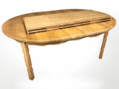 A 20th century Danish blond oak extending dining table with three leaves,
