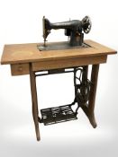A Singer treadle sewing machine in oak table