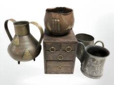 A miniature oak chest of drawers, 13 cm, together with an Art Nouveau copper pot,