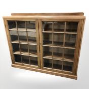 A 20th century glazed mahogany double door bookcase,