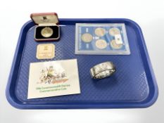 A Pobjoy Mint tercentenary crown, together with a silver bangle,
