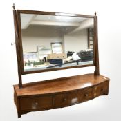 A reproduction mahogany bow-fronted dressing table mirror,