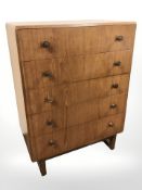 A 20th century teak and ply five drawer chest,
