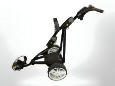 A Powakaddy electric golf caddy with battery pack and charger