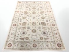 A machine made rug of Persian design,