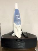 A Gold Star digital radio (with remote) and a Vax handheld vacuum cleaner.