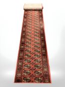 A machine made runner of Turkoman design,
