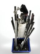 A golf bag and crate of clubs and equipment