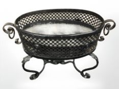 A wrought metal planter, width 73 cm.