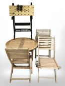 A teak folding garden table and three chairs, together with a folding workbench.