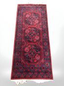 A machine made runner of Turkoman design, 177 cm x 70 cm.