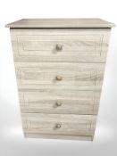 A contemporary MDF four drawer chest, 58 cm x 40 cm x 88 cm.