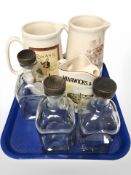 Three pottery jugs bearing advertising including Cowan's Whisky,