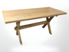 A 20th century pine refectory dining able on X-framed support,