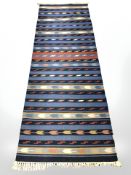 An Eastern flatweave kilim runner, 260 cm x 87 cm.