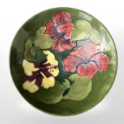 A Moorcroft Hibiscus bowl on green ground, diameter 18 cm.