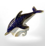 A Royal Crown Derby Dolphin paperweight, with silver stopper.
