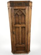 A 1920's carved panelled oak sentry door hall cabinet,