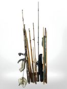 A group of fishing rods, billiards cues and a metal detector.