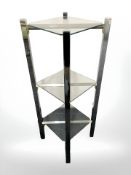 A contemporary chrome and glass three tier stand, height 107 cm.