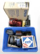 A butane camping stove, Epson scanner in box, Kodak and Fuji digital cameras, car jumpstarter,