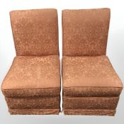 A pair of chairs in salmon floral fabric