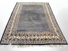 A Saroukh carpet, West Iran, circa 1960, the indigo field with a dense boteh motif,