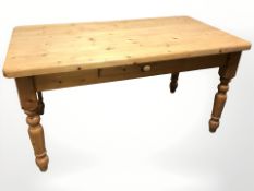 A contemporary pine farmhouse dining table, fitted a drawer, 152 cm x 83 cm x 77 cm.