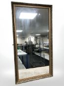 A reproduction gilt framed mirror, 132 cm x 71 cm.