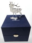 A Swarovski crystal figure of a stag, height 14 cm, boxed.