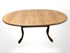 A 20th century G Plan teak extending oval dining table with internal leaf,